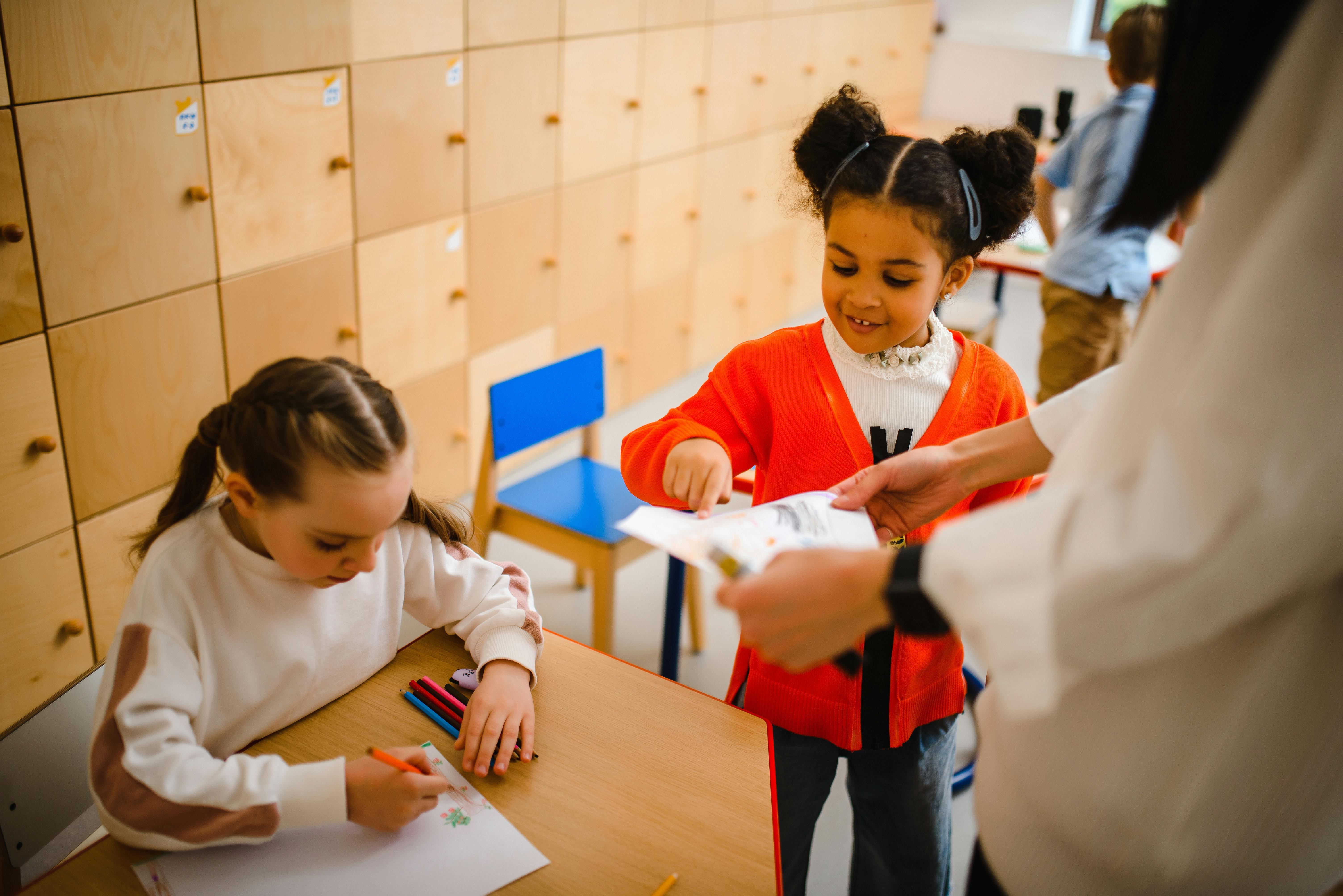 Children learning at a classroom desk
